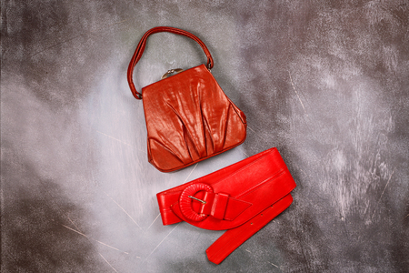 Red leather handbag and belt, retro styled, top viewの写真素材