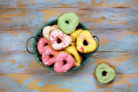 Heart shaped donuts on wooden background, top viewの写真素材
