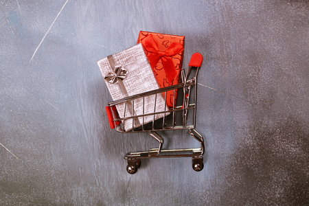Online shopping concept, shopping cart and gift boxesの写真素材