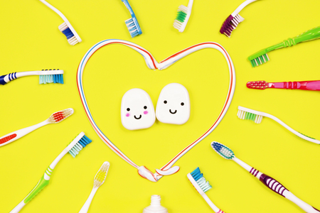 Toothbrushes and dental floss on yellow background,top viewの写真素材