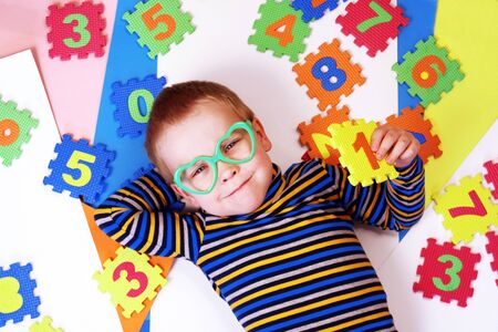 Early childhood education, preschool and kids game concept. Happy baby boy learning to count.の写真素材