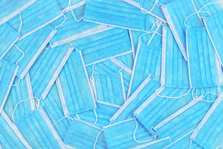 Many disposable medical protective masks, top view. Protection against virus, coronavirus, flu....