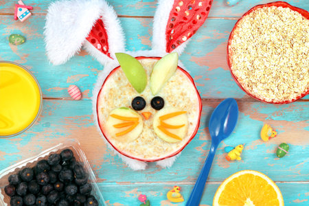 Funny breakfast for kids. oatmeal with fruits and orange juice.の写真素材
