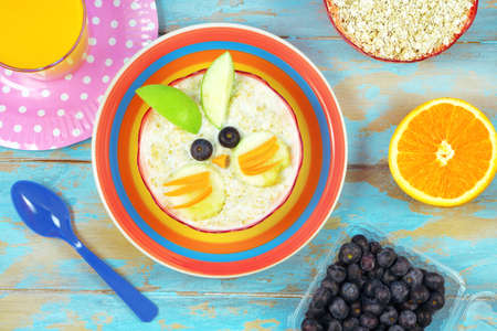 Fun food for kids - cute oatmeal rabbit bunny. Healthy vegetarian eating for childrenの写真素材
