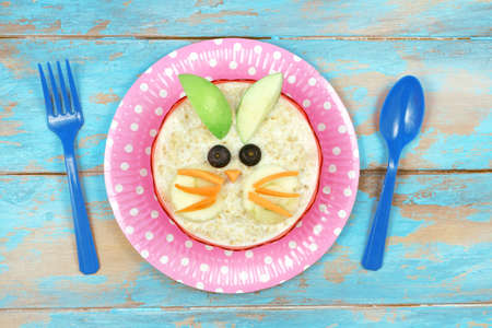 Fun food for kids - cute oatmeal rabbit bunny. Healthy vegetarian eating for childrenの写真素材
