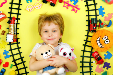 Cute smiling boy hugs stuffed toys. Childhood friendship conceptの写真素材