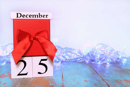 Wooden Block calendar with Christmas date and red gift box on white background. Copy space, space for textの写真素材