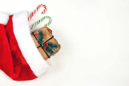 Christmas gift box wrapped in craft paper, homemade packaging , white wooden background, copy space....