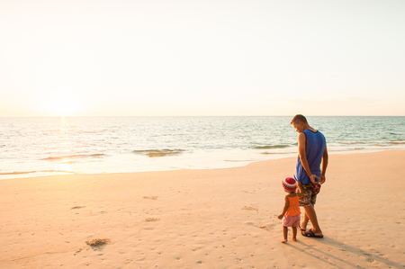 Phang Nga, Thailand â JANUARY 29, 2016: Young girl and father seeing the ocean for the first time on sunset beach of Tai Muang District.のeditorial素材