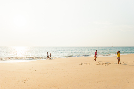 Phang Nga, Thailand â JANUARY 31, 2016: Happy children playing and photograph a beach at sunset. Tai Muang District.のeditorial素材