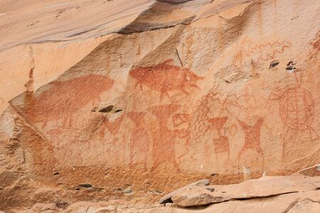 Fantastic ancient paintings on sandstone cliff, 3,000 year-old. Scene in paintings include giant...