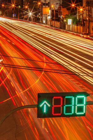 Bangkok rush hour. Intersection, commuter traffic travels at night. Colorful night traffic in the...