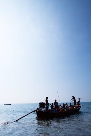 Real life, a Moken family on old traditional boat in the andaman sea, Thailand-Myanmar border. Sea gypsy, Moken live a semi-nomadic hunter-gatherer lifestyle heavily base on the sea.の写真素材