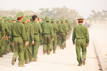 Rear view, a group of Young Vietnamese soldier walking on the street during site visit program of Vietnamese military academies at the bunker of the French General De Castries. Dien Bien Phu, Vietnam. Blurred, Backgrounds. Out of focus.のeditorial素材