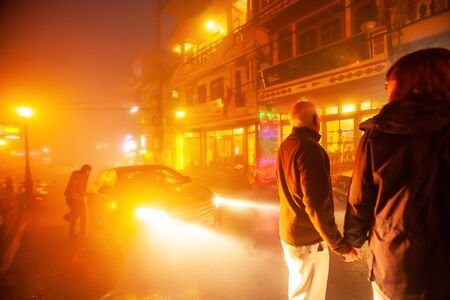 Couple european holding hands together on the night street market at Sa Pa, tourist attractions in North Vietnam. Love-emotion. Motion blur.の写真素材
