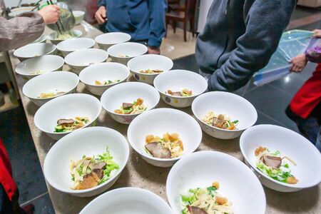 Yunnanese egg noodles with pork and vegetables in white bowls at a local restaurant, the local food...
