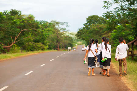 Back view of a group of Laotian high school walking home from school, rural scene in South Laos.のeditorial素材