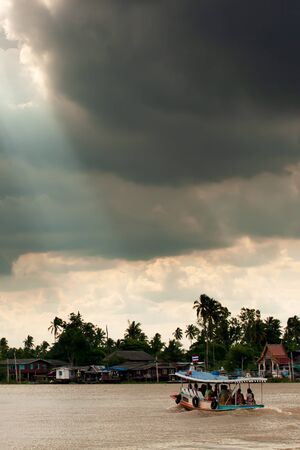 Dramatic rainstorm over ferryboat on Chao Phraya River, the major river in Thailand.の写真素材