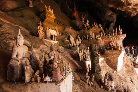 Myriad ancient Buddha statues and sculptures in Pak Ou Caves or Tham Ting, tourist attractions in Luang Prabang, Laos.の写真素材