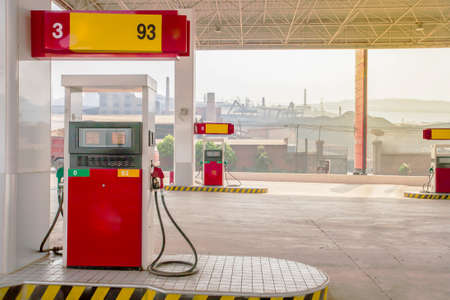 A local gas station and coal mining in the background along the road to South China. Energy, Climate change concepts.の写真素材