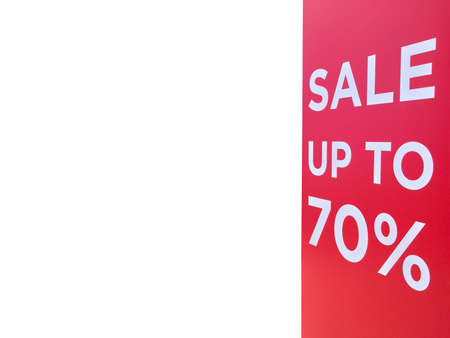 Sale sign text or sale banner on red wall at a retail shopping mall entrance, isolated on white...