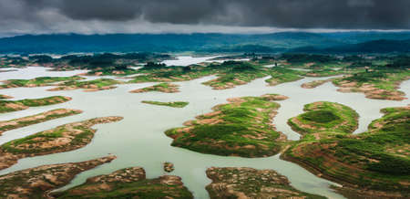 Aerial view of a dam and tropical rainforest flooded. Climate change, Environment concepts.の写真素材