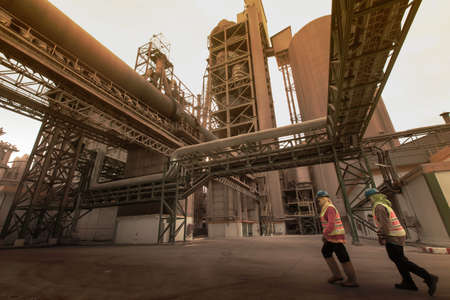 Females laborer works overtime in a coal mining site. Motion blur. Focus on tower.の写真素材