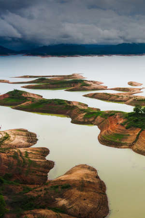 Aerial view of a dam and tropical rainforest flooded. Climate change, Environment concepts.の写真素材