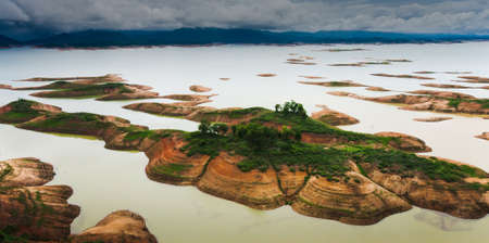 Aerial view of a dam and tropical rainforest flooded. Climate change, Environment concepts.の写真素材