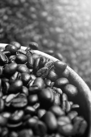 Coffee beans fresh roasted textures. Roasted coffee beans on silver scoop in an Asian traditional way. Close-up. Top view. Flat lay. Selective focus.の写真素材