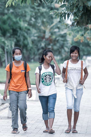 Battambang, Cambodia - SEPTEMBER 21, 2013: A group of Khmer teenage girls walks in a park. Battambang Province.のeditorial素材