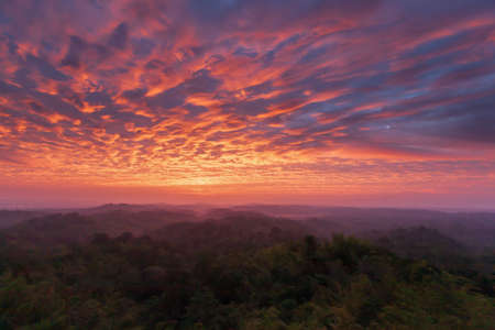 Dramatic clouds on the sunrise sky over mountains range. Magical ripples clouds on the morning sky. North Thailand. Holiday, vacations, tourism concepts. Focus on clouds.の写真素材