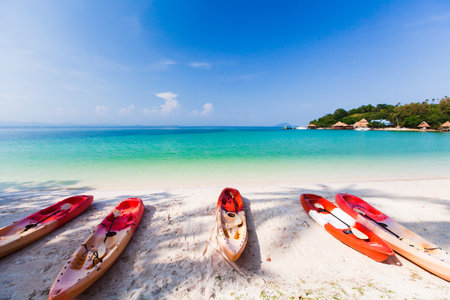 Sea kayaks on the sand beach on sunny summer. luxury resort in the background. Koh Talu Island, Thailand. Holiday, vacations, tourism concepts.の写真素材