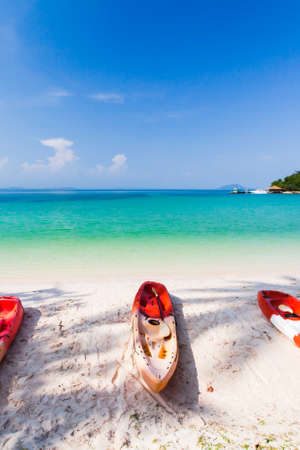 Sea kayaks on the sand beach on sunny summer. luxury resort in the background. Koh Talu Island, Thailand. Holiday, vacations, tourism concepts.の写真素材