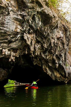 Kayaking through the channel island in a deep lagoon surrounded by green mangrove forest. Thale Ban National Park, South Thailand. Exploration, tourism concepts.の写真素材