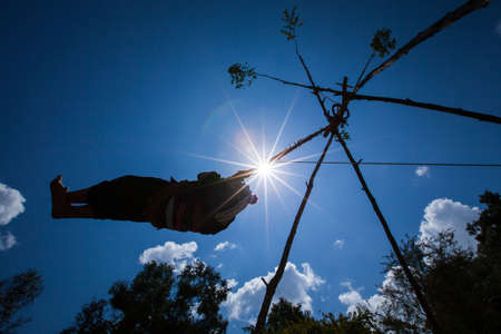 Akha hill tribe Swing Ceremony during new year festival or Akha swing festival. Chiang Rai, Thailand. Silhouette. Blur motion.の写真素材