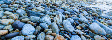 Horizontal a tropical pebble beach in summer, abstract layers, pattern, and the surface of the...