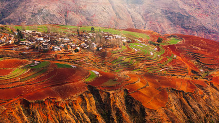 The scenery of mountains terraces views or Dongchuan Red Land, an ancient village surrounded by colorful soil terracing. Tourist attractions in China.の写真素材