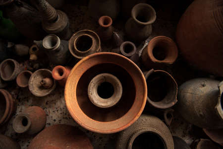 A group of ancient pottery vessels was displayed at the local museum of Sing Buri, Thailand. Art, cultures concepts. Top view. Close-up. The museum is open to the public.の写真素材