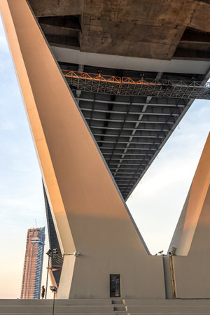A female walks past the large two-column bent suspension bridge over the Chao Phraya River during...