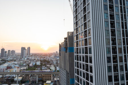 Aerial view of the Bangkok skyline during sunset, the residential building under construction next...