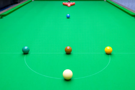 High-angle view of a snooker table with the balls in their starting positions.