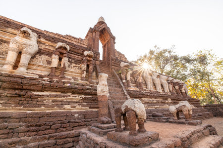 The landscape of the ancient temple at Wat Chang Rob is decorated with stucco elephant sculptures. Kamphaeng Phet Historical Park. UNESCO World Heritage Site.の写真素材