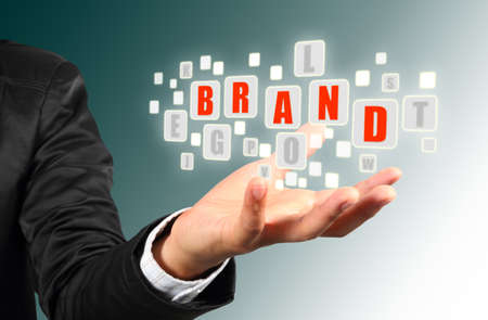 Businessman hand holding with red brand  alphabet streaming imagesの写真素材
