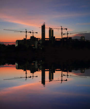 Reflection of construction site in sunset backgroundの写真素材