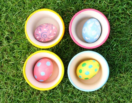 Pastel Eggs with 4 Cups in Grassの写真素材