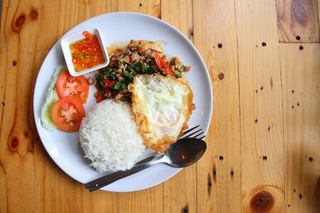 egg, pork fried rice, breakfast food on brown wooden background.の写真素材