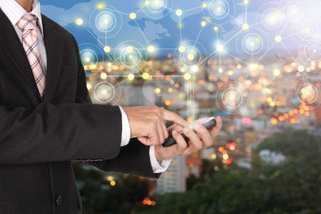 business technology connection hand phone world and downtown city blur bokeh abstract.の写真素材