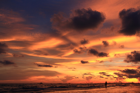 Sunset background and people silhuouette on the beachの写真素材
