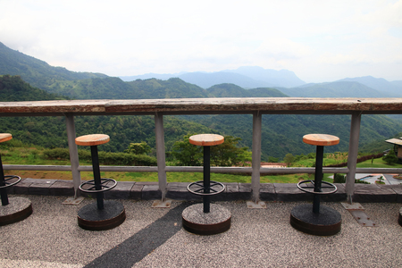 brown chair steel and wood retro in restaurant on fog and green hill background outdoor.の写真素材
